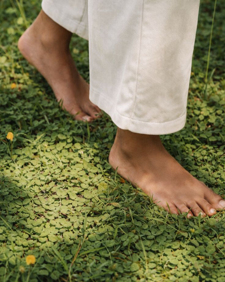 Bare feet on lush grass — grounded in the land